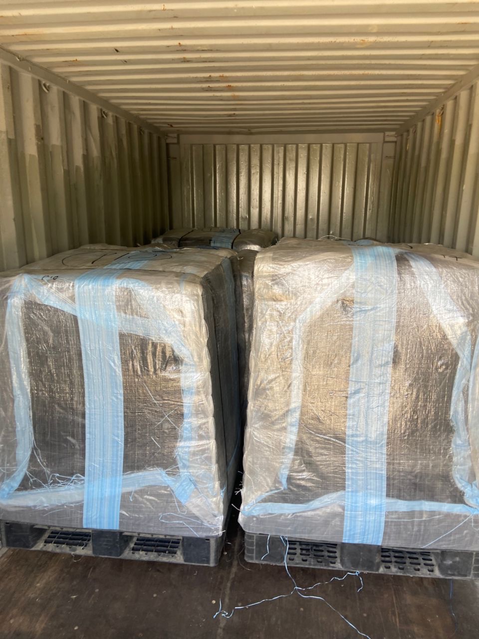 Wrapped and strapped pallets inside a container.